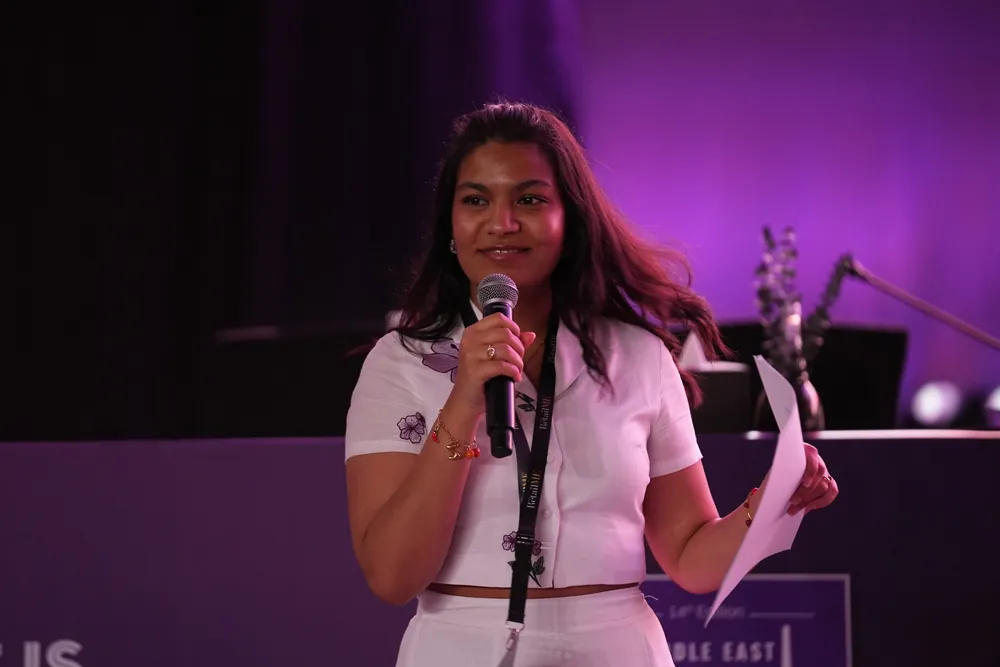 Zahabiya hosting on stage with a microphone at an IMAGES RetailME event