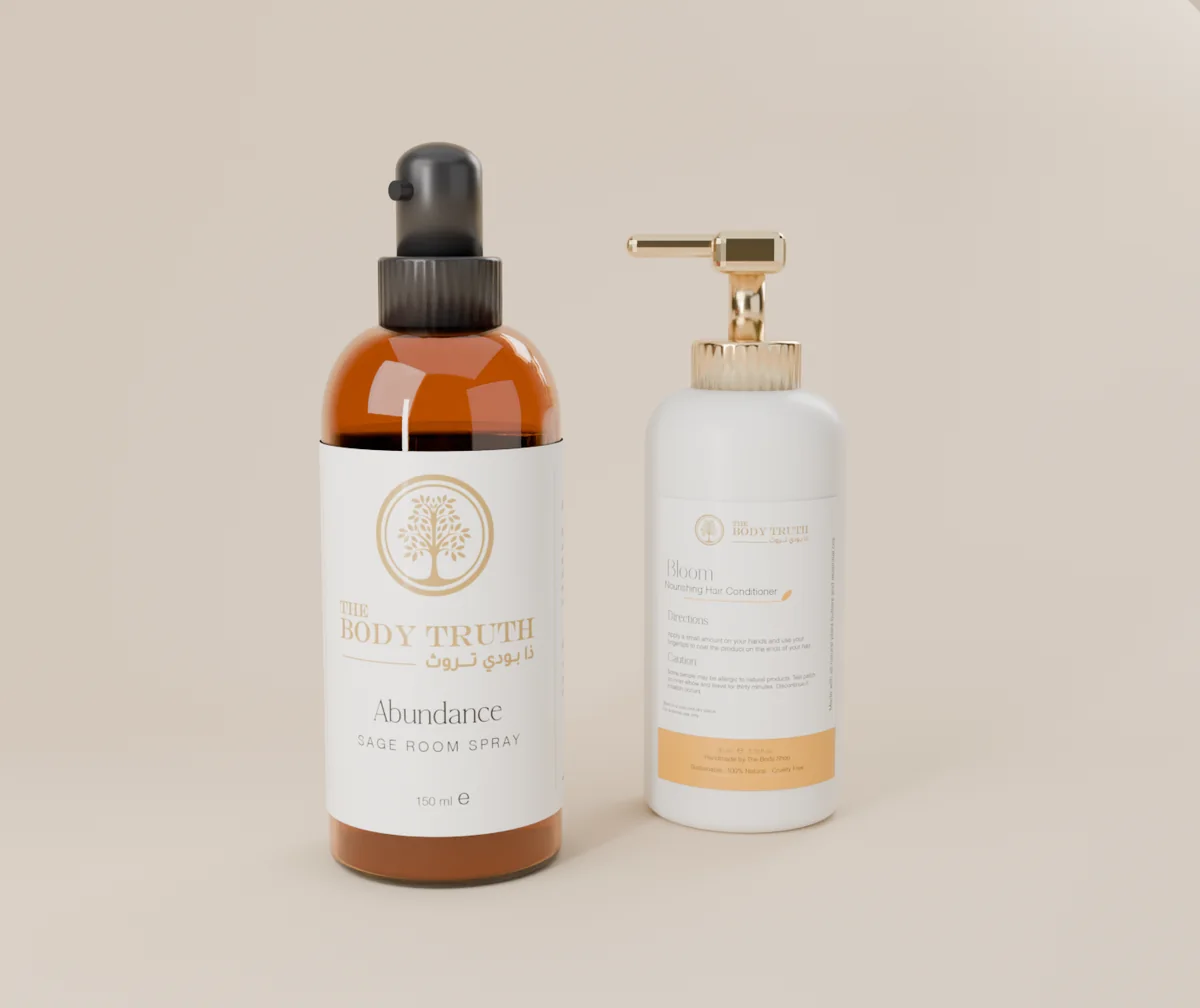 The Body Truth Abundance sage room spray in an amber glass bottle beside the Bloom hair conditioner in a white pump bottle